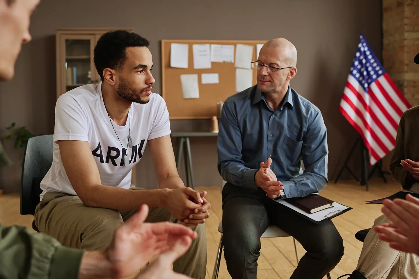 Male experienced psychotherapist listening to young depressed man